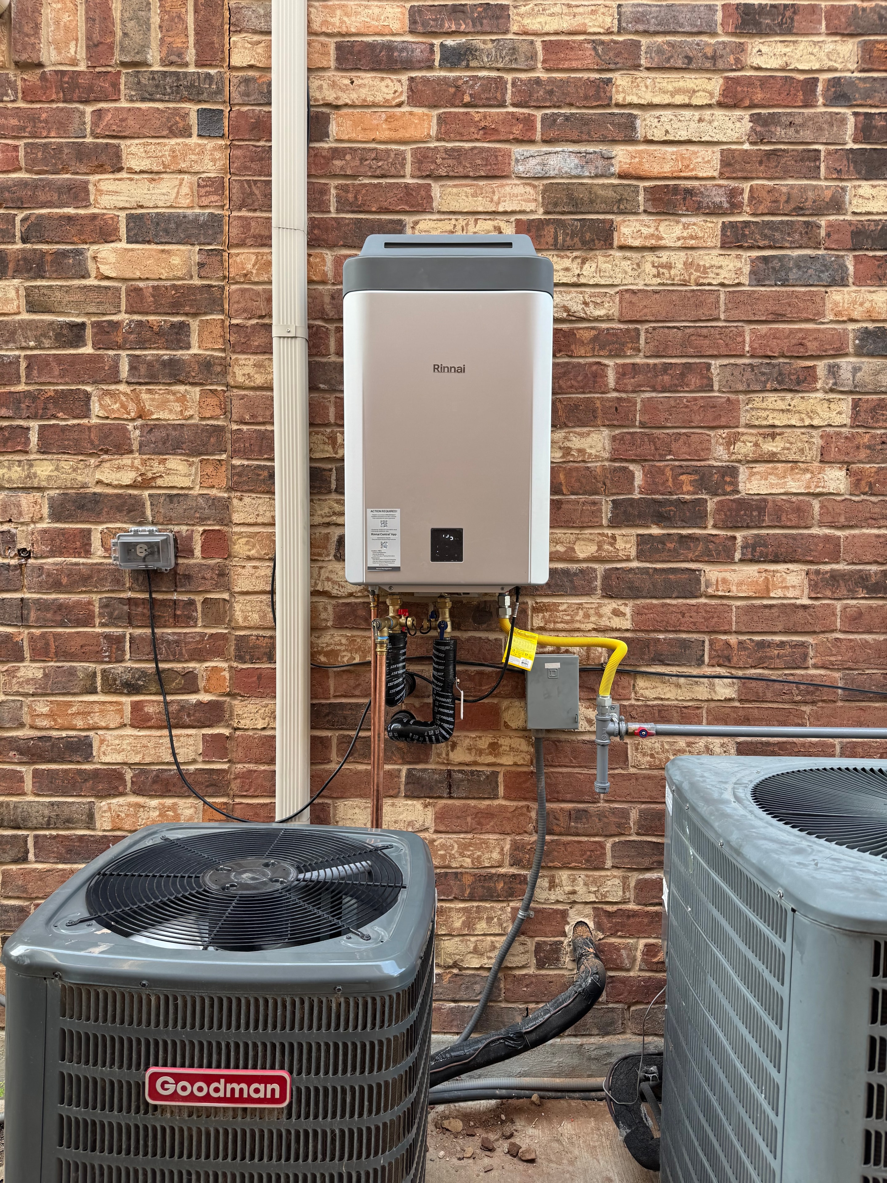 Rinnai tankless water heater on brick exterior wall